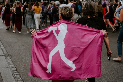 women equality megaphone demonstration flag Claudio Schwarz Unsplash