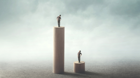 photo of man on tall stand and man on small stand representing inequality