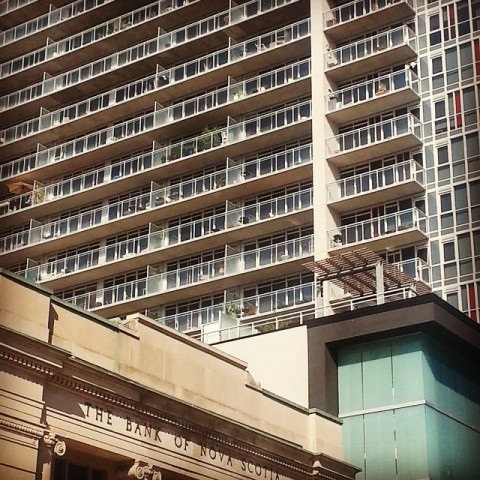 A highrise in Ottawa with the roof of an old Bank of Nova Scotia in the foreground