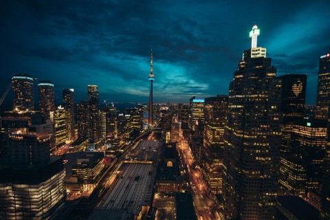 Aerial photo of Toronto at night with a bright-dark blue sky with beautiful clouds